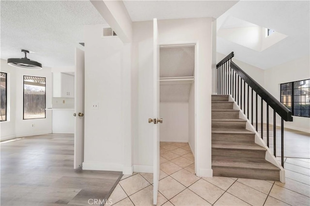 14225 Woodpark Dr, Moreno Valley, CA 92553 - stairs with plenty of natural light, a skylight, and wood finished floors
