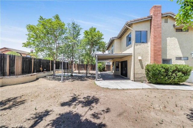 14225 Woodpark Dr, Moreno Valley, CA 92553 - back of house featuring stucco siding, a fenced backyard, a chimney, and a patio