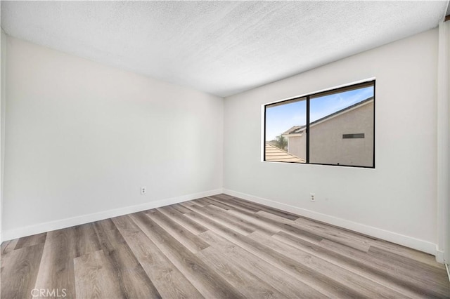 14225 Woodpark Dr, Moreno Valley, CA 92553 - spare room featuring a textured ceiling and wood finished floors