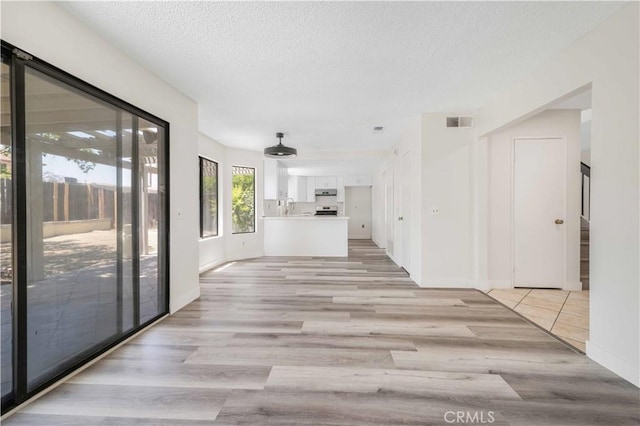 14225 Woodpark Dr, Moreno Valley, CA 92553 - hallway featuring light wood-type flooring and a textured ceiling