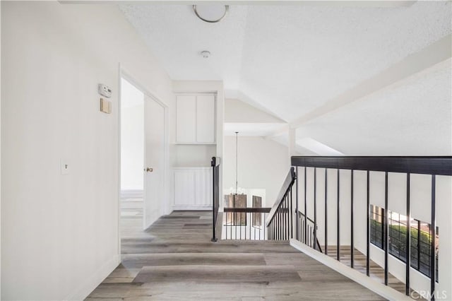 14225 Woodpark Dr, Moreno Valley, CA 92553 - stairway with wood finished floors, lofted ceiling, a chandelier, and a textured ceiling