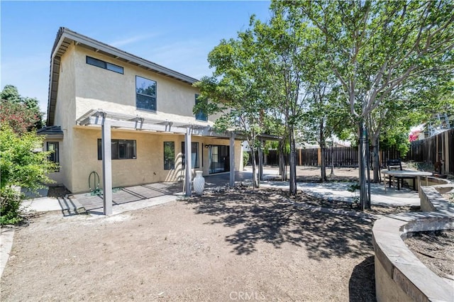14225 Woodpark Dr, Moreno Valley, CA 92553 - back of property featuring stucco siding, a patio, and a pergola