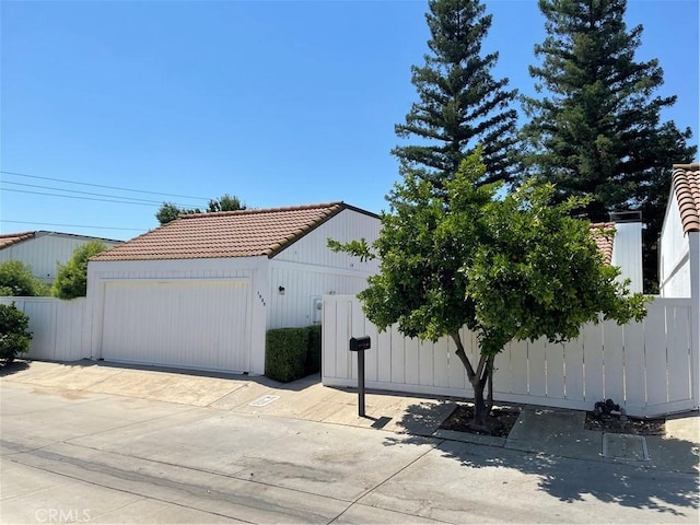 1935 W Santa Ana Ave, Fresno, CA 93705 - view of front facade with a tiled roof and a garage