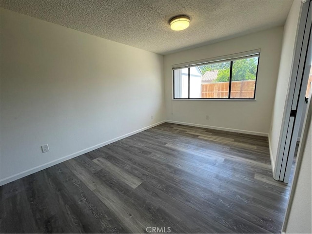 1935 W Santa Ana Ave, Fresno, CA 93705 - unfurnished room featuring dark wood-type flooring and a textured ceiling