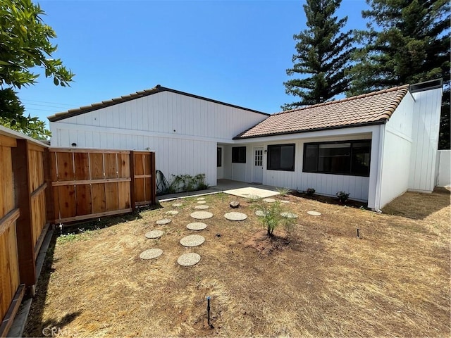 1935 W Santa Ana Ave, Fresno, CA 93705 - rear view of property featuring a tiled roof and a patio