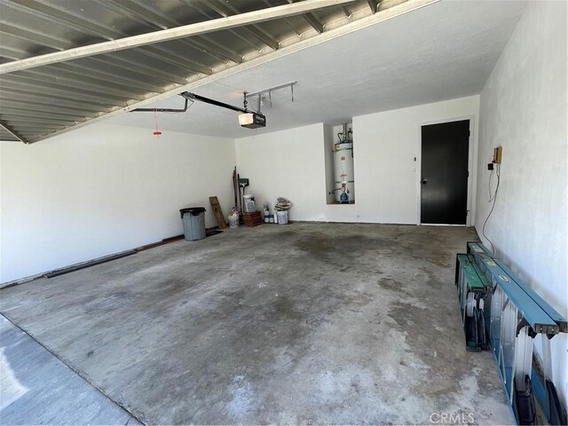 1935 W Santa Ana Ave, Fresno, CA 93705 - garage featuring a garage door opener and water heater