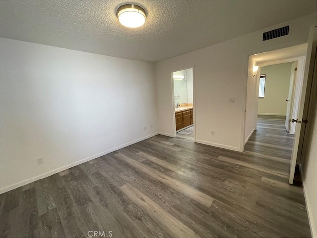 1935 W Santa Ana Ave, Fresno, CA 93705 - empty room featuring dark wood-type flooring and a textured ceiling