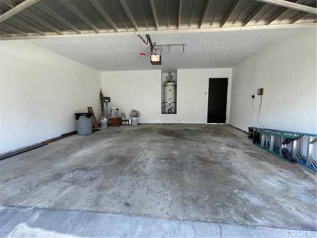 1935 W Santa Ana Ave, Fresno, CA 93705 - garage featuring a garage door opener and strapped water heater