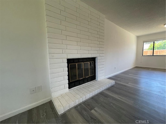 1935 W Santa Ana Ave, Fresno, CA 93705 - detailed view of wood finished floors, a fireplace, and a textured ceiling