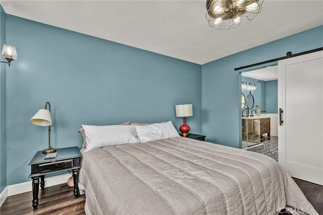 19072 Redbud Rd, Hidden Valley Lake, CA 95467 - bedroom featuring a barn door, wood finished floors, and ensuite bathroom