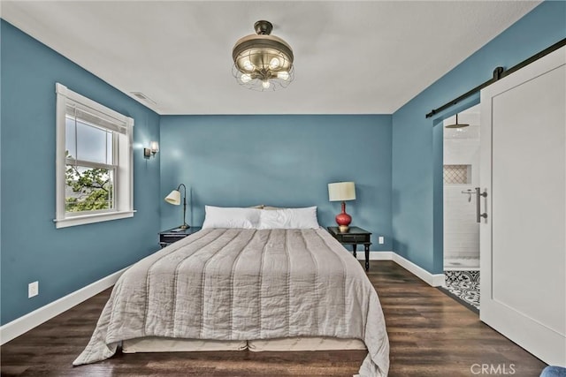 19072 Redbud Rd, Hidden Valley Lake, CA 95467 - bedroom with wood finished floors, a barn door, and ensuite bath