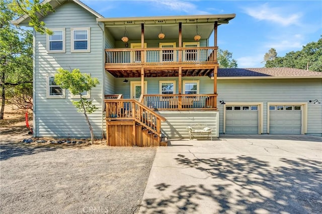19072 Redbud Rd, Hidden Valley Lake, CA 95467 - view of front of property featuring a balcony, covered porch, driveway, and an attached garage