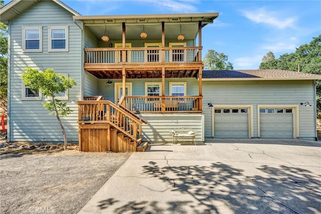 19072 Redbud Rd, Hidden Valley Lake, CA 95467 - view of front of home featuring a balcony, driveway, a garage, and covered porch