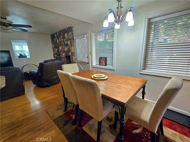 2445 Spring Dr, Running Springs, CA 92382 - dining space with wood finished floors, a chandelier, and a ceiling fan