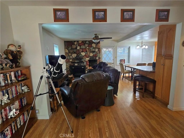 2445 Spring Dr, Running Springs, CA 92382 - living area with light wood-type flooring, a ceiling fan, a fireplace, and a chandelier