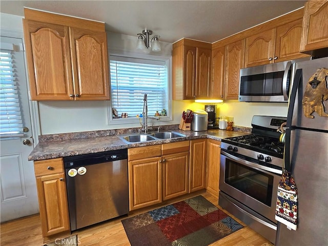 2445 Spring Dr, Running Springs, CA 92382 - kitchen featuring stainless steel appliances, healthy amount of natural light, light wood-style floors, and brown cabinets