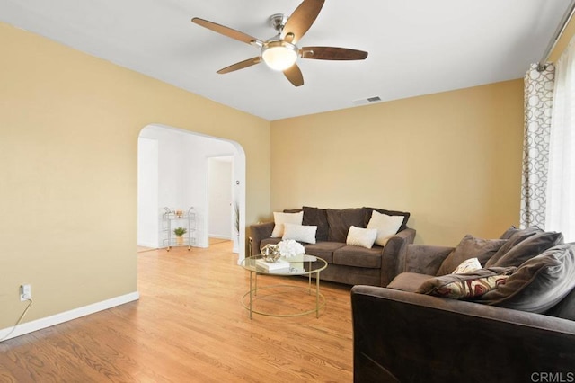 6038 Bradford St, San Diego, CA 92115 - living area with a ceiling fan, arched walkways, and light wood-style flooring