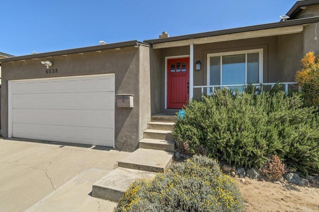 6038 Bradford St, San Diego, CA 92115 - view of front of house with stucco siding, an attached garage, and concrete driveway