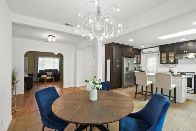 6038 Bradford St, San Diego, CA 92115 - dining space with arched walkways, recessed lighting, and a chandelier