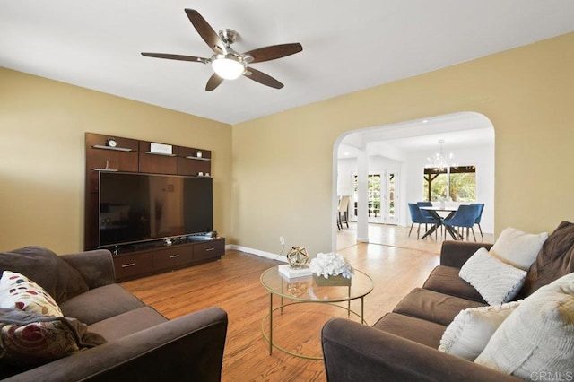 6038 Bradford St, San Diego, CA 92115 - living room with arched walkways, a chandelier, a ceiling fan, and wood finished floors