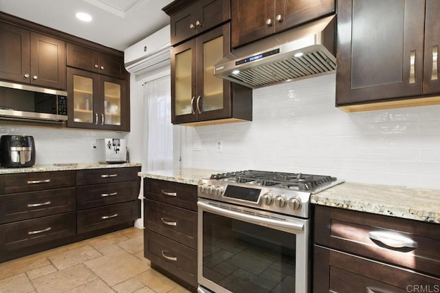 6038 Bradford St, San Diego, CA 92115 - kitchen with stainless steel appliances, ventilation hood, backsplash, dark brown cabinetry, and recessed lighting