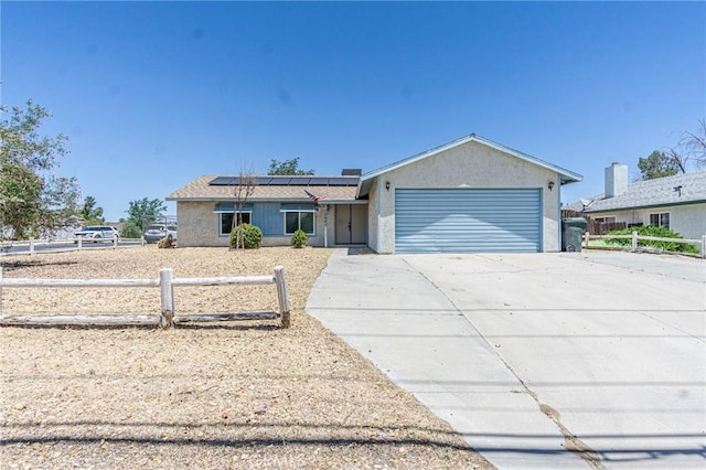 15660 Yates Rd, Victorville, CA 92395 - single story home with a garage, roof mounted solar panels, and concrete driveway