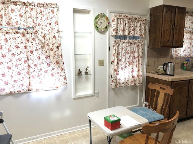 662 Kempton Ave, Monterey Park, CA 91755 - kitchen with tile countertops, dark brown cabinetry, backsplash, and light flooring