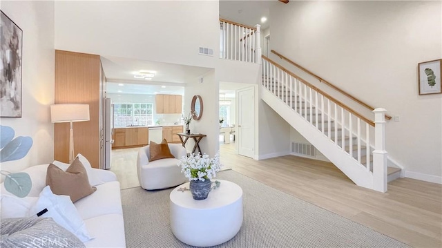4 Skipper, Irvine, CA 92604 - living area with light wood finished floors, stairs, and a high ceiling