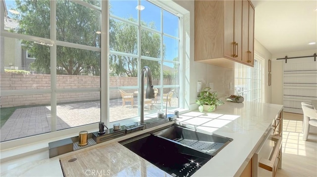 4 Skipper, Irvine, CA 92604 - kitchen with a barn door, light stone counters, and light brown cabinetry