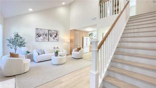 4 Skipper, Irvine, CA 92604 - living room featuring wood finished floors, high vaulted ceiling, stairway, and recessed lighting