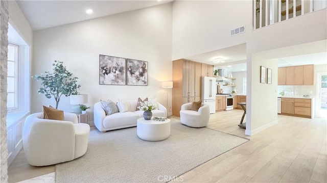 4 Skipper, Irvine, CA 92604 - living area with light wood-style flooring and a high ceiling