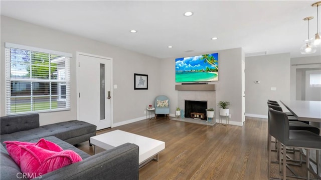 5202 E Conant St, Long Beach, CA 90808 - living area with wood finished floors, recessed lighting, and a fireplace with flush hearth