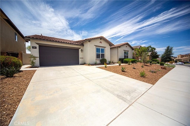 35115 Mahogany Glen Dr, Winchester, CA 92596 - mediterranean / spanish-style home featuring concrete driveway, stucco siding, a garage, and a tile roof