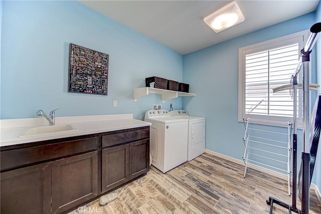 35115 Mahogany Glen Dr, Winchester, CA 92596 - laundry room featuring washer and clothes dryer, cabinet space, and light wood finished floors