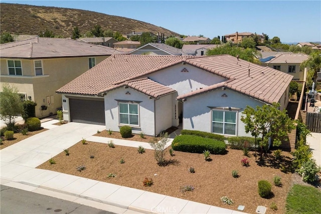 35115 Mahogany Glen Dr, Winchester, CA 92596 - mediterranean / spanish house with an attached garage, stucco siding, concrete driveway, and a tiled roof