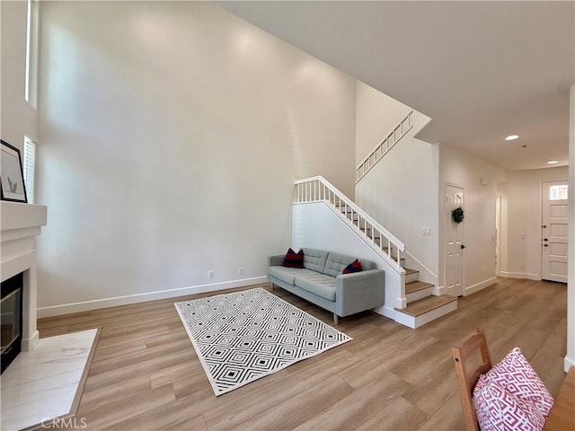 13390 Savanna, Tustin, CA 92782 - living area with stairway, wood finished floors, recessed lighting, and a fireplace with flush hearth