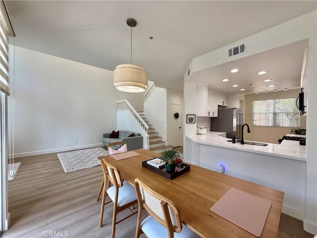 13390 Savanna, Tustin, CA 92782 - dining room with light wood-style floors, stairway, and recessed lighting