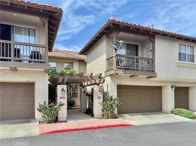 13390 Savanna, Tustin, CA 92782 - view of front of house featuring a balcony, stucco siding, a garage, and a tiled roof