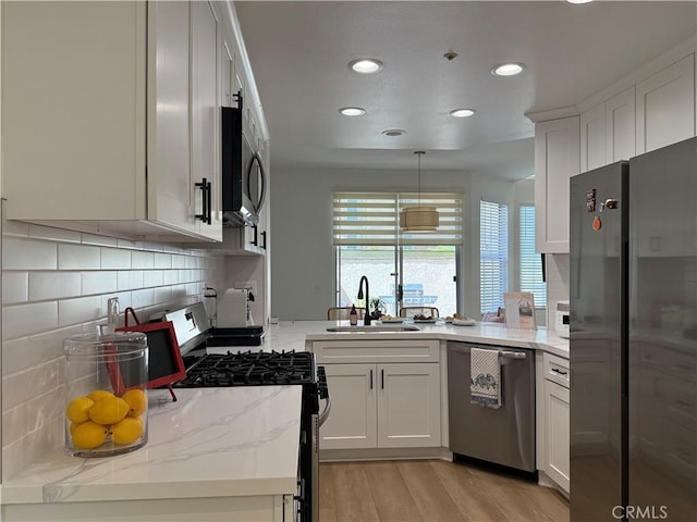 13390 Savanna, Tustin, CA 92782 - kitchen featuring stainless steel appliances, tasteful backsplash, recessed lighting, white cabinets, and light wood-type flooring
