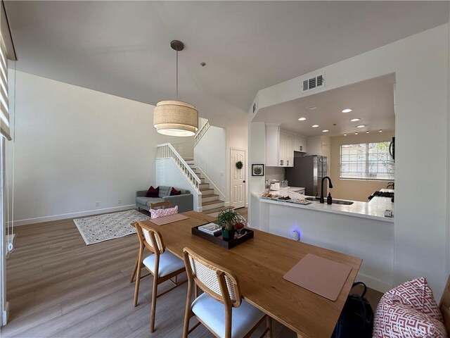 13390 Savanna, Tustin, CA 92782 - dining room featuring light wood-style flooring, stairs, and recessed lighting