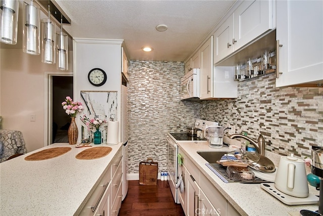 225 W 6th St Unit 206, Long Beach, CA 90802 - kitchen featuring white appliances, white cabinetry, backsplash, dark wood-type flooring, and light stone countertops