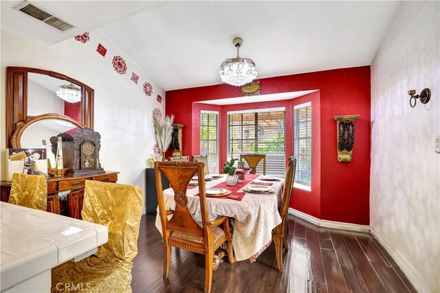 12161 Napoli Dr, Cerritos, CA 90703 - dining room with an accent wall, a chandelier, wood finished floors, and wallpapered walls