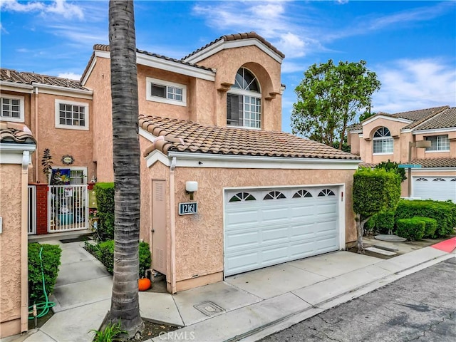 12161 Napoli Dr, Cerritos, CA 90703 - view of front facade featuring a tiled roof, a garage, stucco siding, and driveway