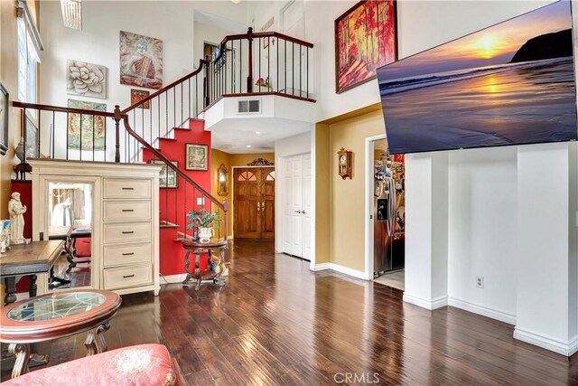 12161 Napoli Dr, Cerritos, CA 90703 - foyer entrance featuring hardwood / wood-style flooring, stairway, and a towering ceiling