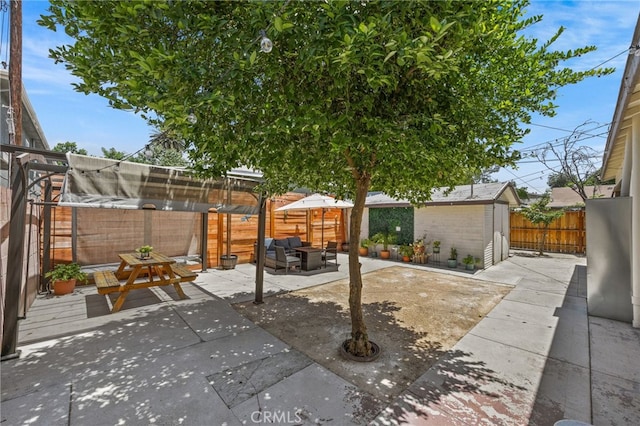 156 W Wabash St, San Bernardino, CA 92405 - fenced backyard featuring outdoor lounge area, an outdoor structure, and a patio area