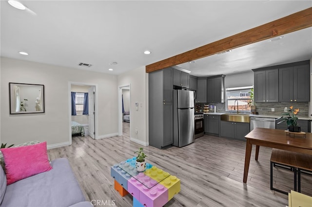 156 W Wabash St, San Bernardino, CA 92405 - living area featuring light wood-style floors, recessed lighting, and beamed ceiling