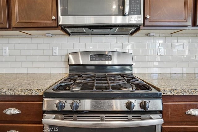 29234 St Andrews, Lake Elsinore, CA 92530 - kitchen with stainless steel appliances, tasteful backsplash, and light stone counters