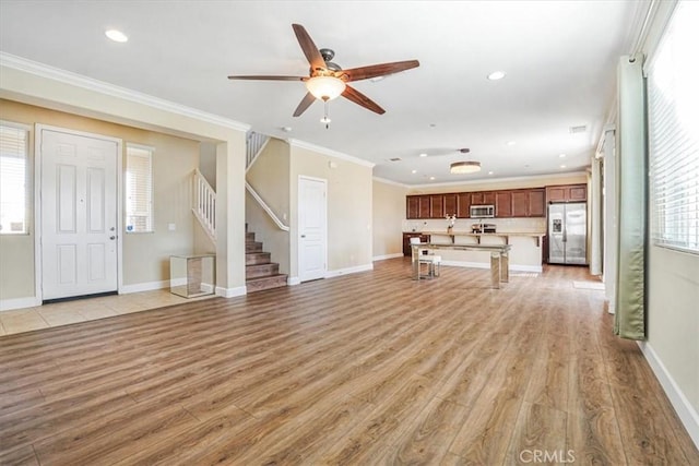 29234 St Andrews, Lake Elsinore, CA 92530 - unfurnished living room with a ceiling fan, recessed lighting, light wood-style floors, healthy amount of natural light, and crown molding
