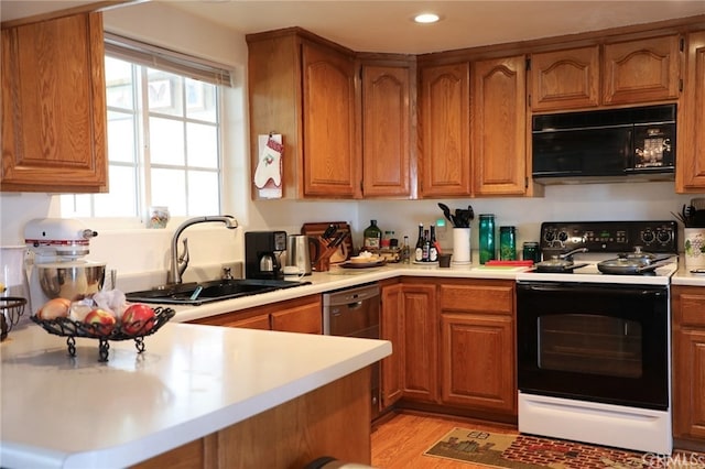 61849 Alta Mesa Dr, Joshua Tree, CA 92252 - kitchen with black microwave, range with electric stovetop, brown cabinets, light countertops, and recessed lighting