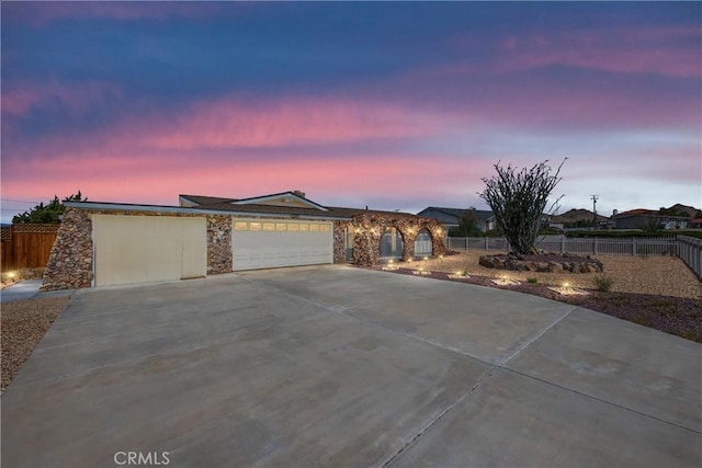 16048 Wintun Rd, Apple Valley, CA 92307 - ranch-style house with stone siding, an attached garage, and concrete driveway